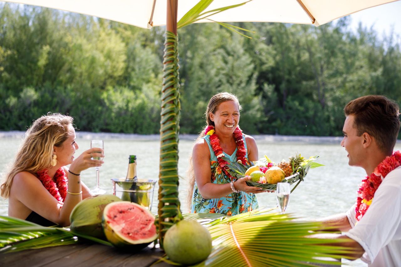 A couple having lunch on a private island in Bora Bora